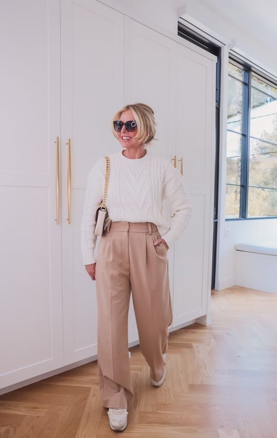 White cable-knit sweater with beige Aritzia Effortless Pant